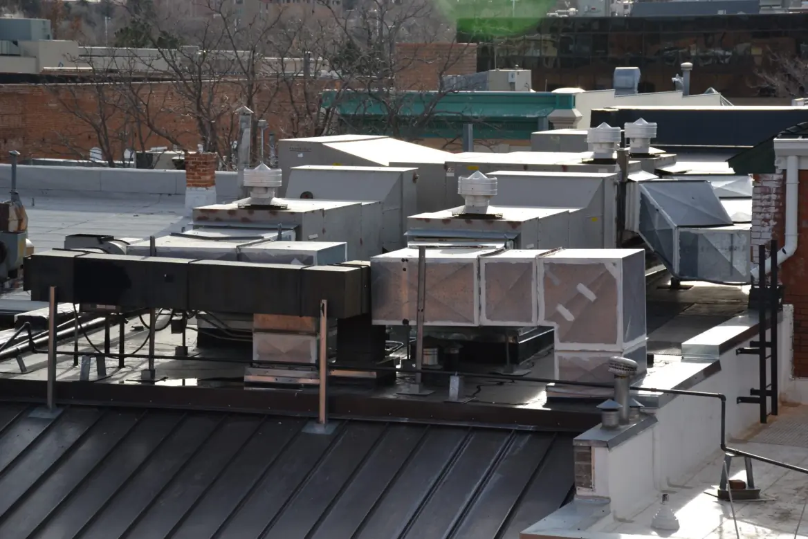 Photograph showing the flat roof and HVAC systems of a commercial building.